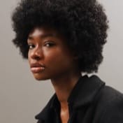 Portrait of Jessica Randall, a black curly haired woman in profile